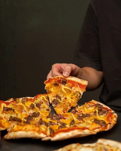 Pizza finishing touch in the kitchen
